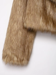 Close-up detail of warm brown faux fur texture on fashionable women's winter coat