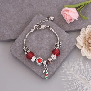 Detail of Christmas beaded bracelet with red glass beads and candy cane pendant