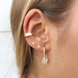 Close-up of gold S925 sterling silver initial A and M earrings with cubic zirconia