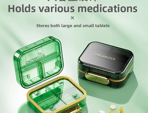 Detail view of the 4-compartment portable pill organizer with secure golden buckles