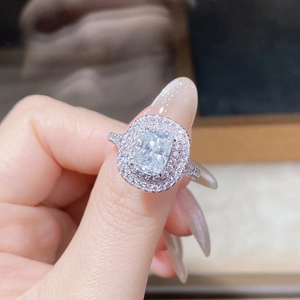 Macro shot of a radiant cut moissanite ring with a double halo setting in silver