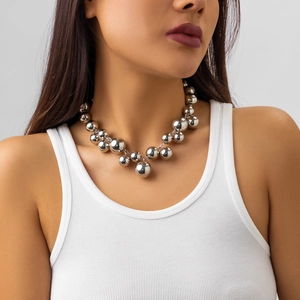 Detail of silver metallic beaded necklace showing industrial punk style on a model