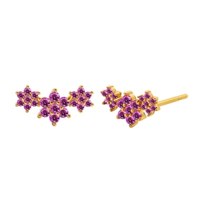 Detail of gold floral earrings with rose red zircon stones on a white background