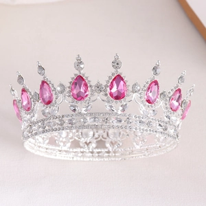 Detailed macro view of silver bridal tiara with pink teardrop gems and clear rhinestones
