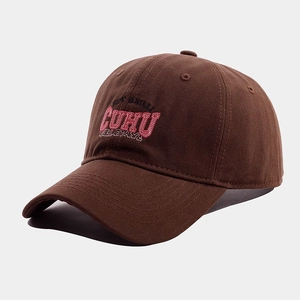 Detailed close-up of pink CUHU letter embroidery on a brown cotton twill baseball cap