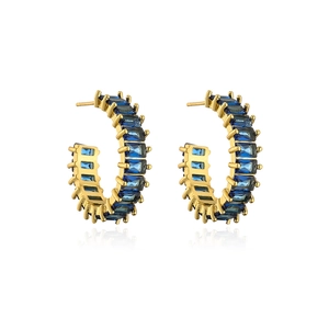Detail of 18K gold-plated C-shaped earrings with rectangular blue zircon stones