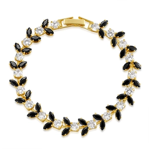 Detail of gold-plated bracelet with black marquise and clear round zircon stones