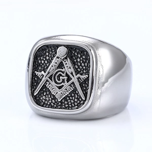 Macro detail of vintage Masonic ring with G logo and retro black textured finish