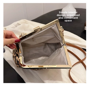 Internal view of the leopard print shell bag featuring grey lining and a zipper pocket