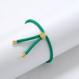 Detail of green braided Tree of Life bracelet with gold adjustable slider buckle