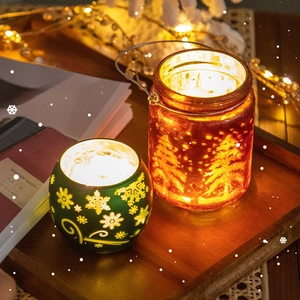 Christmas candle holder ornaments with glowing warm light and snowflake glass jar design