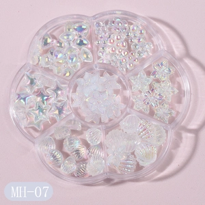 Detailed view of Aurora AB resin nail art charms in a 6-grid transparent organizer box