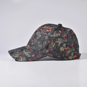 Black graffiti baseball cap with Eiffel Tower and rose prints shown from a side view