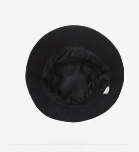 Detail of black bucket hat showing breathable mesh lining and fabric sweatband interior