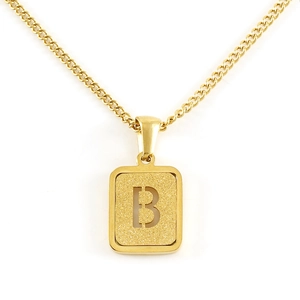 Macro view of gold 18K titanium steel pendant featuring a textured matte letter B design