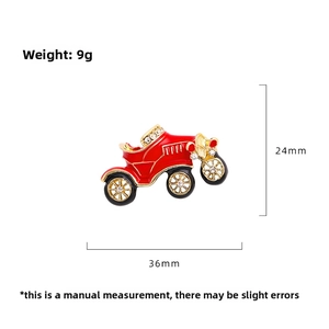 Detailed view of red vintage car brooch with sparkling rhinestones and gold-tone trim