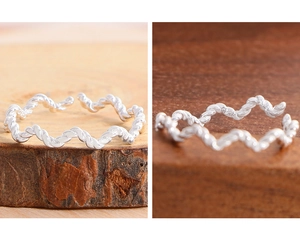 Detailed macro view showing S925 sterling silver stamp on twisted rope wave ring