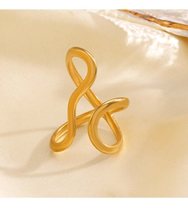 Detailed view of 18K gold plated stainless steel ring with modern wave lines on silk