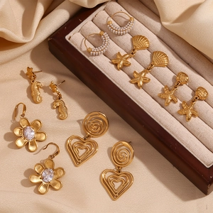 Golden earrings collection with starfish, heart and floral designs in luxury display
