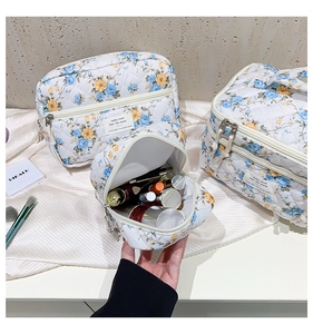 Detail showing the large capacity and floral quilted interior of this makeup bag