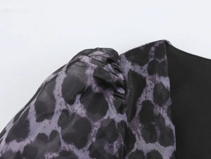 Detail of leopard print chiffon fabric stitching with pleated shoulder design and black organza