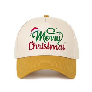 Detail of Merry Christmas embroidery on cream and yellow two-tone trucker cap