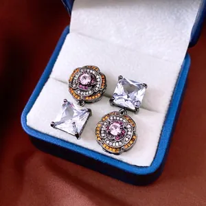 Vintage asymmetrical camellia earrings with black metal and sparkling zircon stones