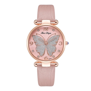 Close-up of pink fashion watch featuring a glitter butterfly pattern and rose gold case