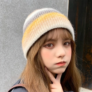 Detailed texture of tie-dye gradient knit beanie in grey and orange for winter