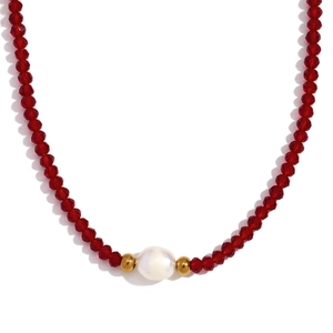 Vintage style necklace featuring red faceted beads with a center pearl and gold accents