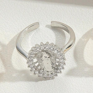 Macro view of S925 silver adjustable ring with relief medallion and paved crystals
