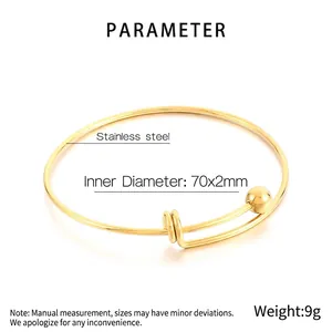 Detailed view of gold stainless steel bangle with sphere ends and 70x2mm inner diameter