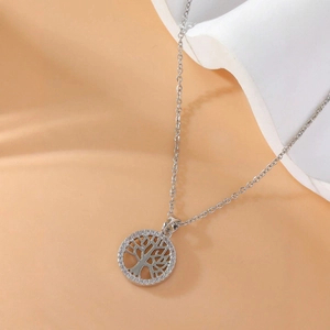 Silver tree of life necklace with white zircon stones on a sleek display stand