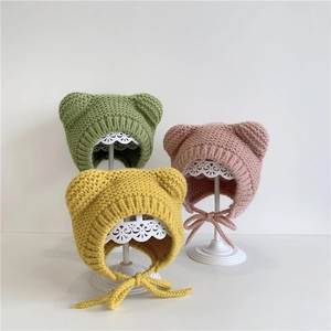 Plush winter baby beanie with bear ears and chin straps in green, pink and yellow