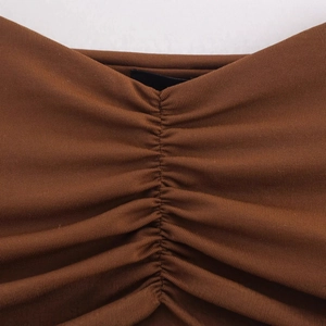 Brown ribbed knit dress with elegant ruched detailing and slim fit texture design