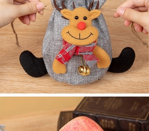 Detail of Christmas reindeer drawstring gift bag with jingling bell and linen texture