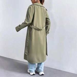 Rear view of long army green trench coat with waist belt and sleeve strap details