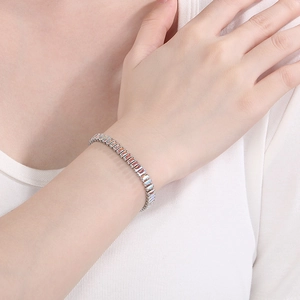 Elegant silver chain bracelet with rectangular multicolored zirconia crystals on wrist