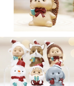 Close-up of cute Christmas resin figurines featuring hedgehog and santa characters
