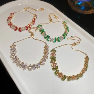 Detailed macro view of adjustable flower bracelets with green and red zircon stones