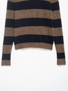 Detailed macro view of the brown and navy blue striped knit sweater cuff and hem texture