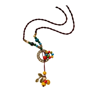 Ethic bohemian necklace with handmade ceramic leaf pendant and colorful wood beads