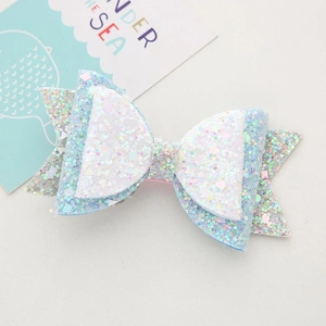 Detail of glittery light blue and white layered bow hair clip for girls with sequins