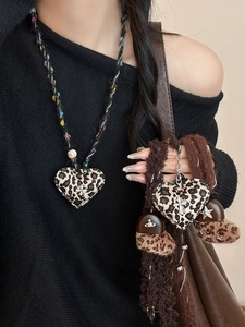 Dettaglio della collana a cuore in peluche leopardato con catena in corda intrecciata