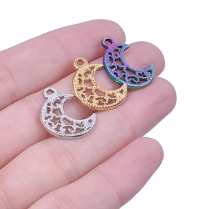 Macro shot of stainless steel crescent moon charms in silver, gold and rainbow finishes