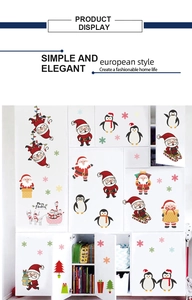 Detailed view of colorful Christmas wall stickers showing Santa and penguins on white cabinets