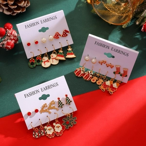 Detailed Christmas earring set featuring Santa and reindeer on festive packaging card