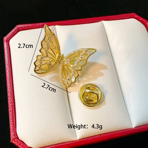 Gold butterfly brooch with sparkling crystals and size specs in a jewelry box