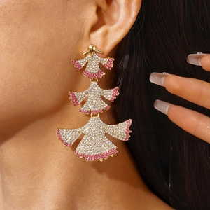 Macro view of luxurious layered fan-shaped earrings with pink and white rhinestones