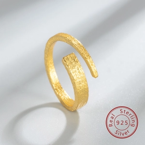 Macro shot of 925 sterling silver ring with irregular matte hammered texture in gold